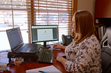 female independent auto insurance agent sits at her desk