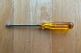 An old screwdriver with an amber-coloured handle.