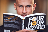 Tim Ferris — look-a-like reading a fake book titled “Four Hour Wizard.” — Tim Ferris Shared His Weirdest Writing Hack