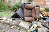 Fly tipped sofa and wreckage