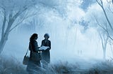 A woman and her former teacher walk together beneath unusually white trees on a moonlit hillside as the teacher hands her a childhood drawing from a worn canvas bag.