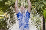 Young man pouring ice water bucket on his head.