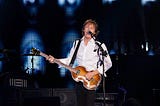 Paul McCartney on stage with his classic bass guitar