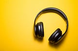 Headphones on a bright yellow background.