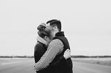 A black and white picture of a women and a man hugging