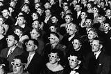 Classic photo of audience members wearing 3D glasses during the first screening of “Bwana Devil,” the first full-length, color 3D movie, November 26, 1952, at the Paramount Theater in Hollywood.