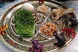 Photo of a traditional Passover Seder plate, lined with plastic frogs.