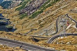 The Transfagarasan road in Romania has many tight curves & winds up a mountain. It gives stunning views & a challenging drive