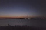 The end of sunset over a large lake, just before twilight