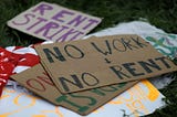 Picture of signs on the ground after people gathered outside an apartment complex with the intention to stop the alleged eviction of one of the tenants in Mount Rainier, Md., last year.