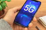 Image of a hand holding a Refurbished iPhone Compatible with 5G Networks.