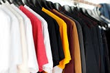 Different colour T-shirts on hangers