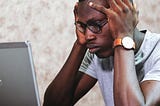 Man looking at computer frustrated or confused