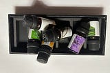 A jumble of small bottles of essential oils in a small box