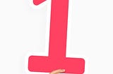 Hand holding a red number 1