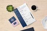 an image of a well-formatted resume on a table, next to a cup of coffee.