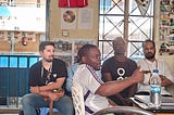 Victor sitting on the side while the Kenyan Futbol Mas team talked about their work.