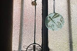 Wedding rings hanging together on dragonfly ornament