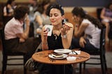 A woman enjoying her Starbuck’s coffee.