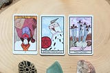 tarot cards with quartz stone on wood