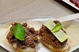 Shank and minced meats prepared in a sauce on white bread and garnished with herbs and cheese (wallaby and venison meats featured for the evening).