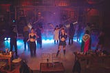 Four people in a relationship with each other spend a night dancing at a cowboy themed bar.