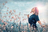 Woman relaxing in a field of flowers
