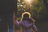 Father and kid walking holding hands