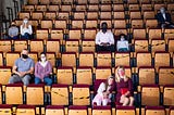 A theater audience with COVID restrictions in place.