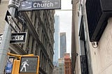 Road signs at the intersection of Church and Dey Streets