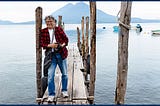 author on a pier with Lake Atitlan in Guatemala behind him