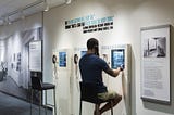 A visitor at the LBJ Library listens to an audio interactive.