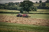 Tractor baling hay in a field