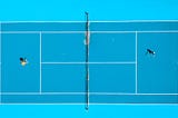 Aerial shot of two tennis players on bright saturated tennis court