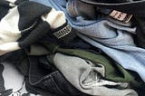 Close up on pile of pants and shirts