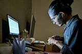 A lady working on her side hustle at night