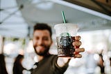 Person holding coffee drink