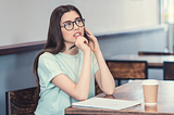 a writer thinking in a coffee shop