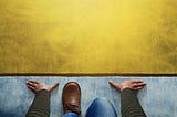 Person crouches at the yellow start line to write their book