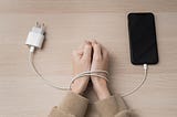 a blogpost feature image for “smartphone charging Tips” — showing a girl hand’s wired-up around a charger and smartphone