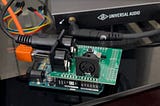 The Arduino UNO with the midi shield attached on top and USB and MIDI cables connected.