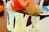 Cheese and tomato on a fork