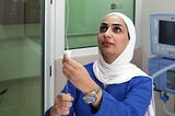 An ICU nurse at Al Karak Hospital prepares an intravenous line.