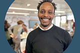 Magid is at a conference, smiling.