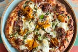 Pizza can be part of a healthy diet when it’s made from food, not additives. Picture of a pizza made at a small cafe using basic ingredients.