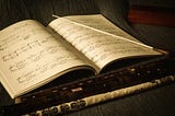 A conductor’s baton lying on an open musical score