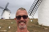 Photo of author in front of the very windmills in Spain that influenced Miguel Cervantes’ most famous scene in the novel Don Quixote.