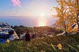 Ghost of Tsushima protagonist Jin Sakai looks out over a grassy hill that stretches down all the way to the coast. Yellow trees frame the view on the right. Ominous ships sail in from the distance.