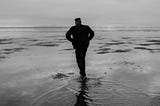 A person walking across a wet path, looking uncomfortable. Your comfort zone might be a lie.