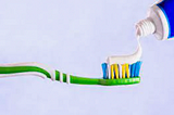 Toothpaste applied over the entire toothbrush, with a twirl at the end for effect